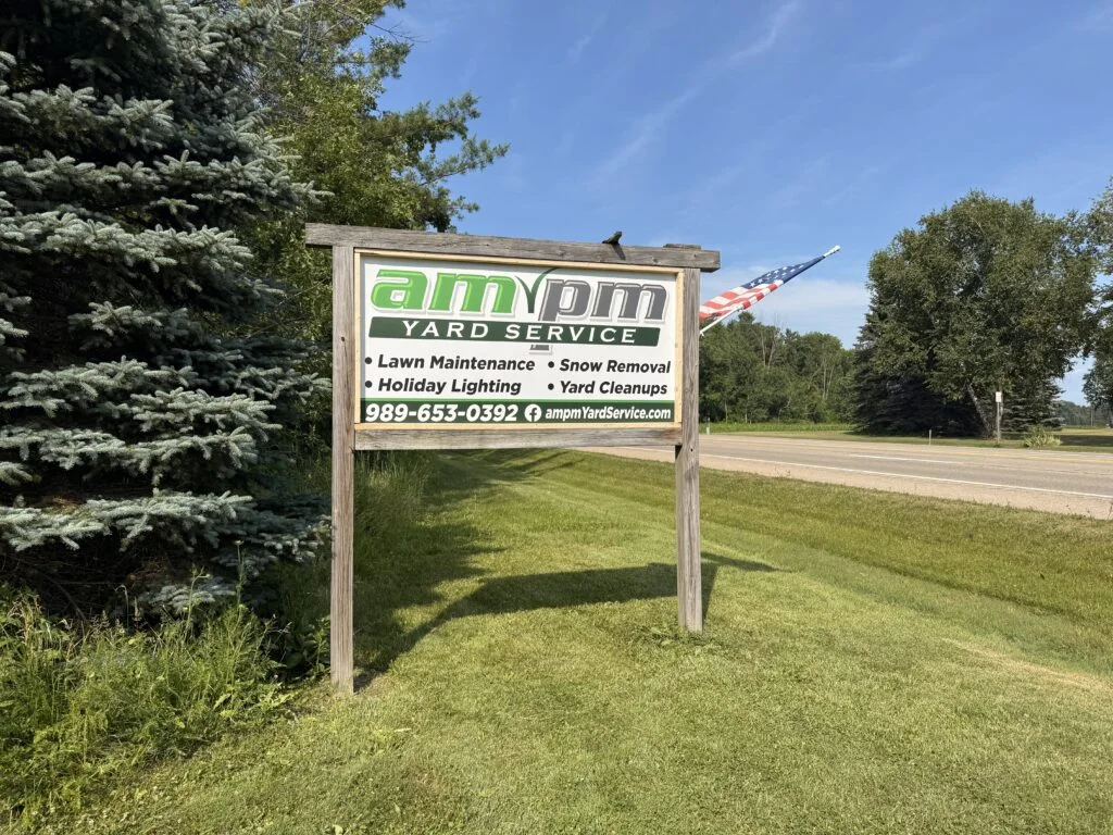 AMPM Yard Service roadside sign beside a maintained lawn